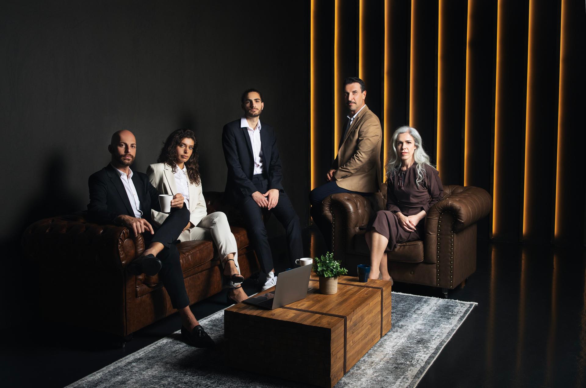 Hispanic Successful Business Team Sitting In Luxury Dark Office